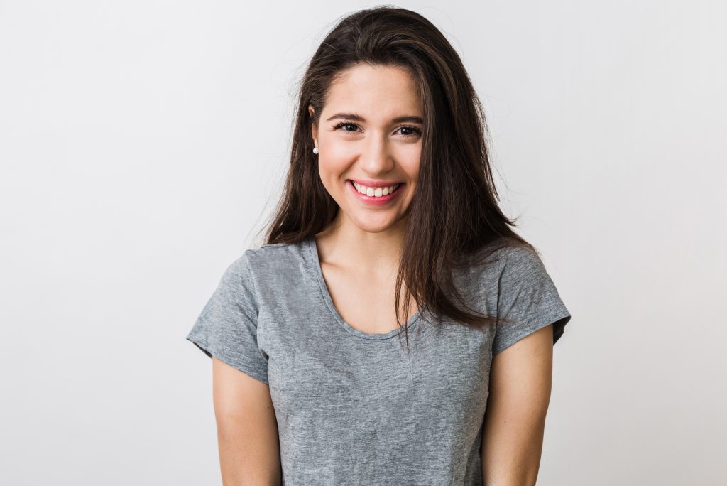 young woman with dark hair smiling