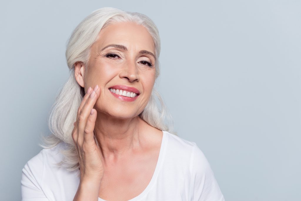 older woman pleased with her dentures