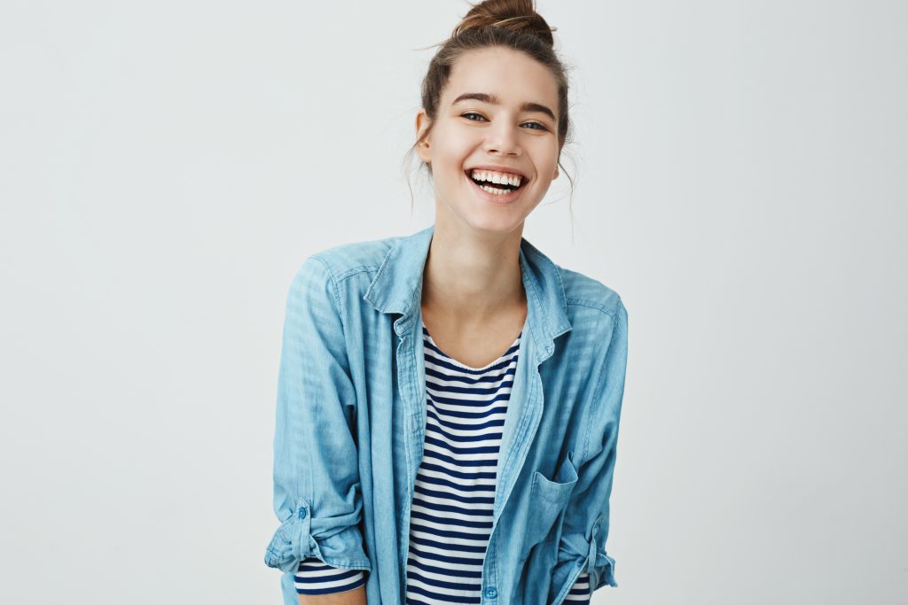 Young woman with hair in bun smiling