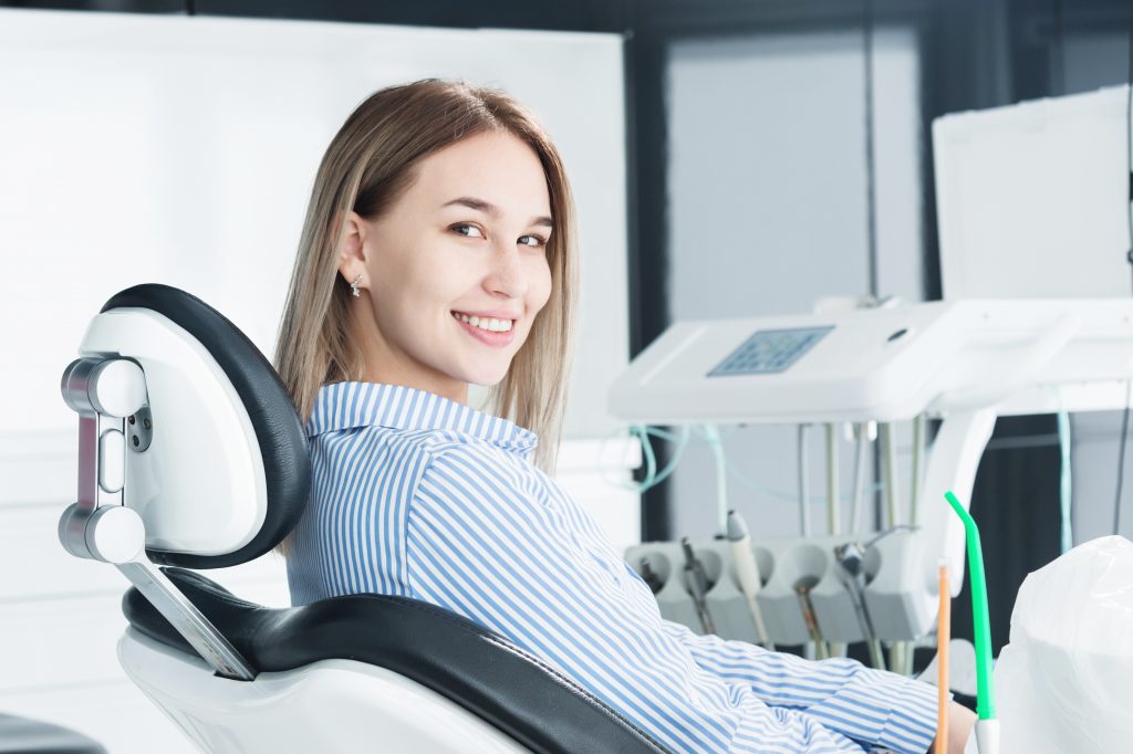 woman in dental chair waiting for dental exam to begin